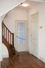 the entrance to the house with the kitchen and living room doors and the stairs to the bedrooms