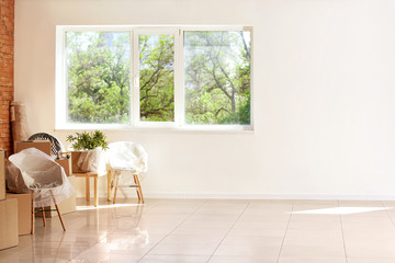 Interior items and packed carton boxes in room. Moving house concept
