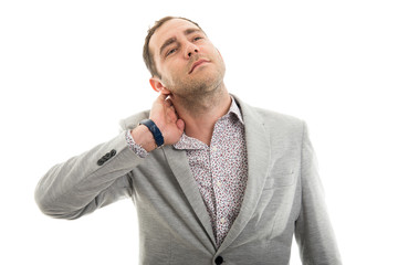 Fototapeta premium Portrait of business man showing neck pain gesture