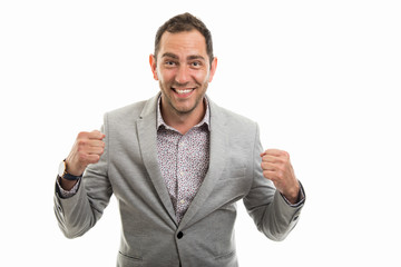 Portrait of business man showing winning gesture