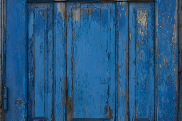 Fragment of blue wooden door. Vintage timber texture background. Rustic view.
