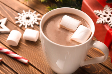 Cup of hot cocoa with marshmallows on wooden table, closeup