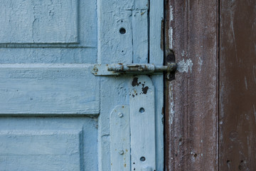 Fragment of blue wooden door. Vintage timber texture background. Rustic view.