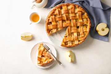 Composition with delicious apple pie on light background