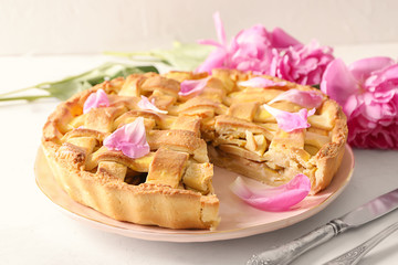 Plate with delicious apple pie on table