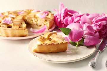 Plate with piece of delicious apple pie on table