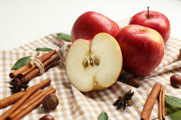 Fototapeta na wymiar Fresh ripe apples and cinnamon on light background