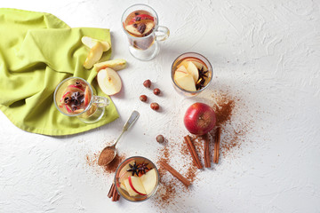 Composition of tea with cinnamon and apples on table