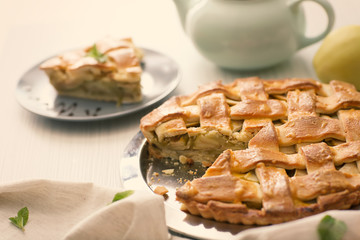 Plate with delicious apple pie on table