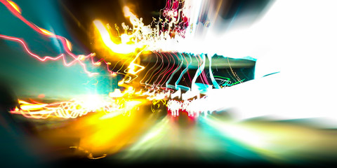 The lights from the fire trucks on the road and highway signs on a long line.