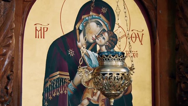 Christian Orthodox Icon Of Virgin Mary And child Jesus Christ. behind the candle