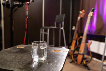 the beginning of the rehearsal in a music ensemble, a glass of water for throat