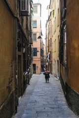 Fototapeta na wymiar Genoa, Italy - June, 12, 2018: street in a center of Genoa, Italy