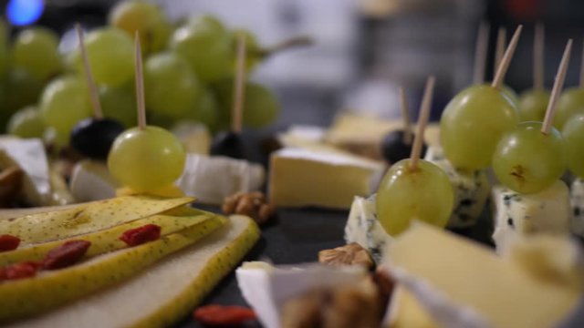 Catering food layout - fruit and cheese snacks are laid out on the table for guests on party
