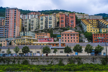 Genoa, Italy - June, 12, 2018:  residential district of Genoa on an embankment of river, Italy