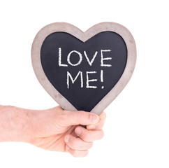 Adult holding heart shaped chalkboard