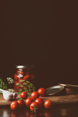 preserved tomatoes and fresh tomatoes on kitchen table