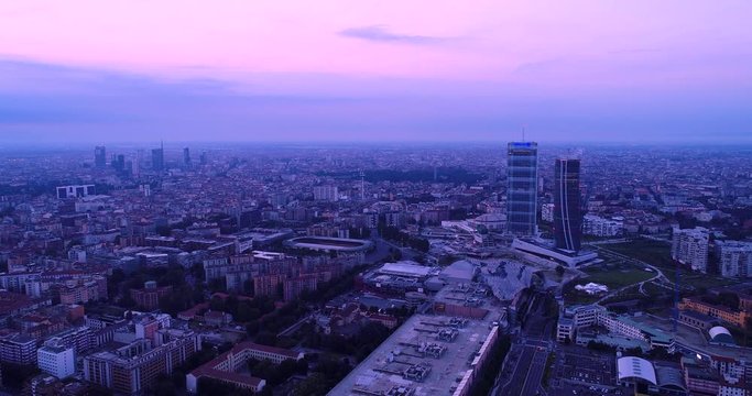 Milan, Italy: Aerial view of Milan at dawn. Flying over the city.