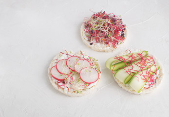 Obraz na płótnie Canvas Healthy snack concept Rice bread Crispy bred Radish slices Sprouts Marrow slices Cottage cheese High key Top view Copy space 