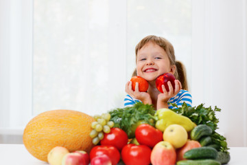 Fototapeta na wymiar Happy little girl and a lot of fruit and vegetables. Concept of