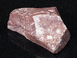 amethyst mineralization on rock on black