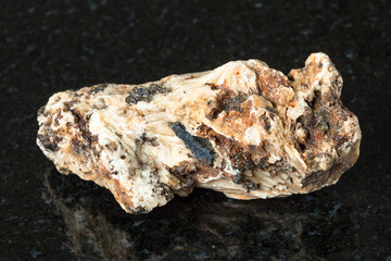 Perovskite stone in rough Clinochlore on black