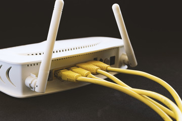Yellow network cables connected in a white modem.