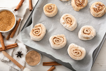 Baking dish with uncooked cinnamon rolls on kitchen table