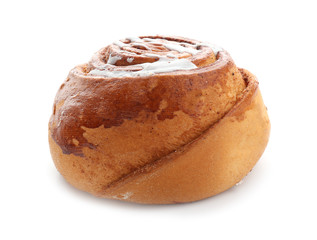 Tasty sweet cinnamon bun with icing on white background