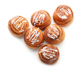 Tasty sweet cinnamon buns with icing on white background
