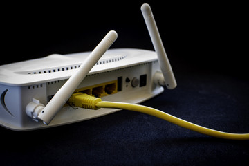 Yellow network cables connected in a white modem.