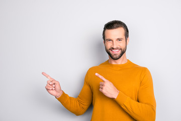 Portrait of cheerful excited expert with idea hairstyle pointing on emphasizing his brilliant idea isolated on gray background copy-space empty blank place