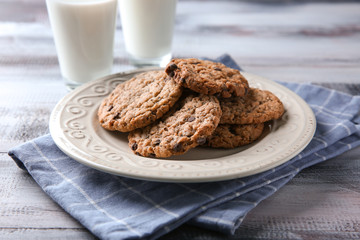 Plate with delicious oatmeal cookies on table