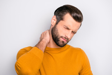 Close up portrait of unhealthy man feeling unwell touching his neck suffering from painful ache isolated on gray background