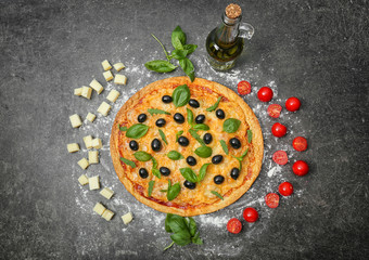 Tasty pizza with olives and ingredients on dark background