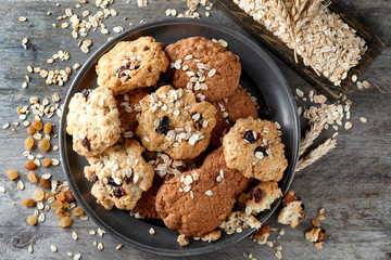 Plate with delicious oatmeal cookies on wooden table