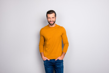 Portrait of attractive handsome with beaming toothy shiny smile with perfect haircut clothed in casual outfit keeping hands in pockets isolated on gray background copy-space