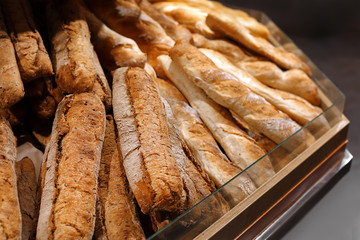 Tasty fresh baguettes on display in bakery