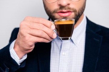 Cropped close up photo of tasty bitter fresh aromatic hot espresso in glass, confident smart wearing formal outfit checkered shirt drinking coffee in the morning at work isolated on gray background