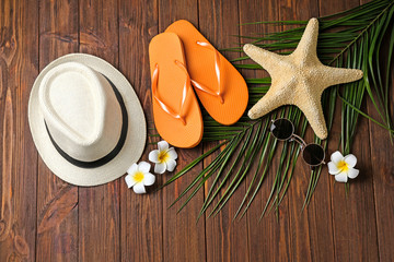 Composition with beach accessories on wooden background