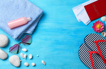 Composition with passport and beach accessories on color wooden background