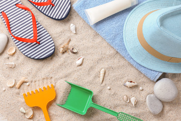 Beach accessories and sea shells on sand