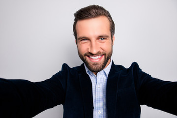 Fun joy enjoy people rest relax concept. Close up portrait of cheerful handsome excited delightful emotional freelancer taking a selfie wearing stylish modern blazer isolated on gray background