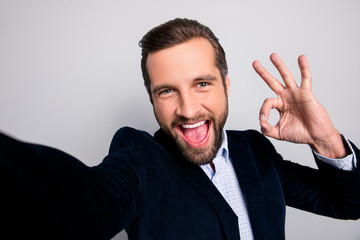 Done good perfect excellent agree like deal people concept. Close up portrait of cheerful excited handsome careless joyful freelancer showing okay symbol taking selfie isolated on gray background