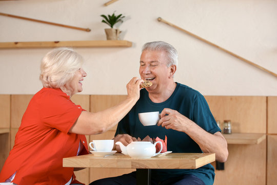 Happy senior couple sitting together in cafe