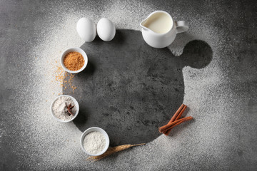 Composition with scattered flour and ingredients on grey background