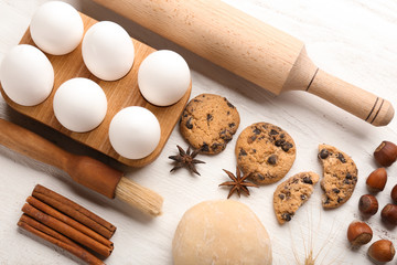 Fototapeta na wymiar Composition with cookies and ingredients for preparing pastries on wooden background