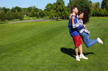 Fototapeta premium Young loving interracial couple having fun outdoors on spring day