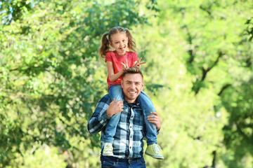 Fototapeta premium Happy father and daughter in green park