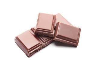 Delicious milk chocolate pieces on white background